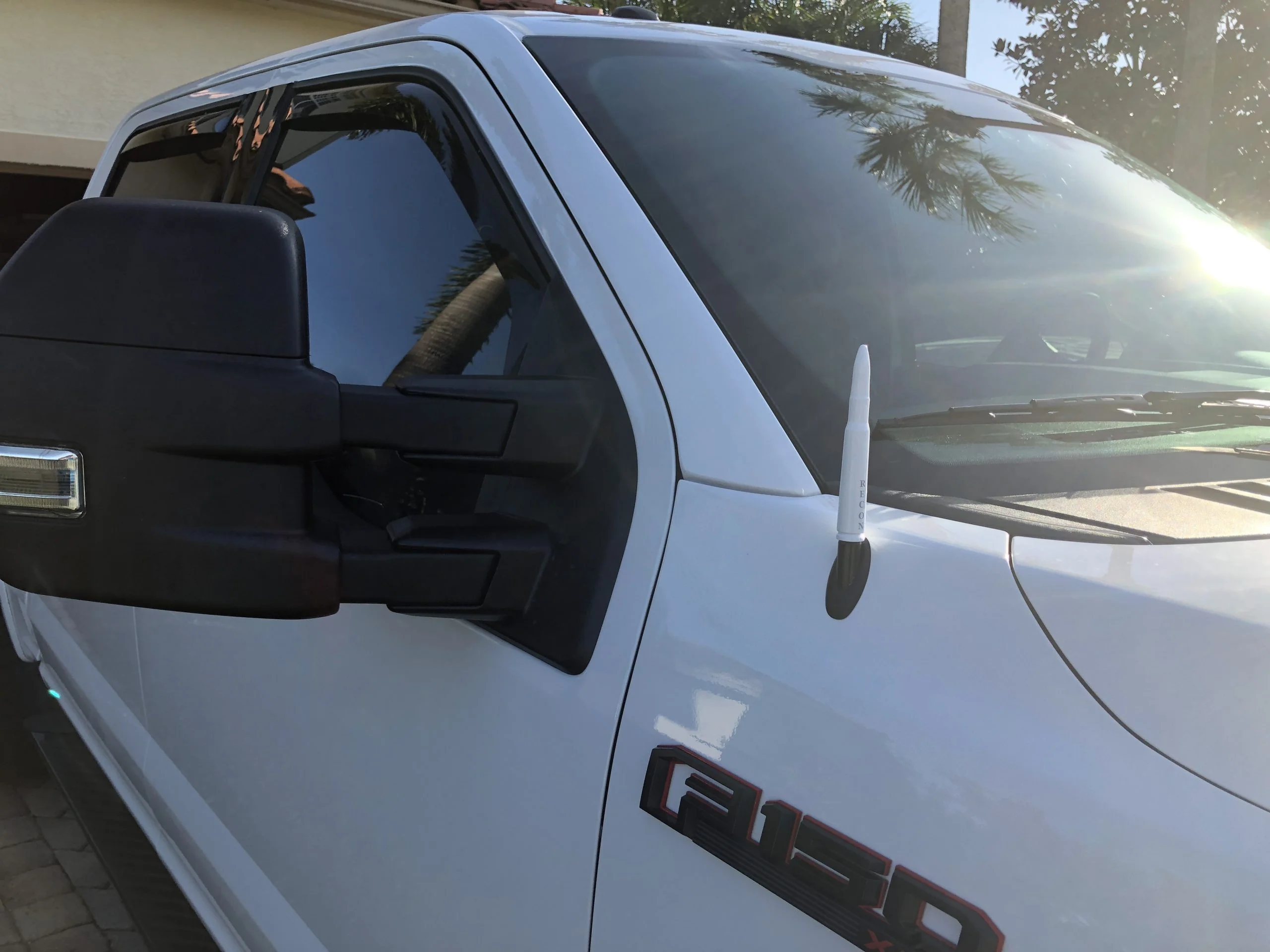 bullet antenna on white ford truck