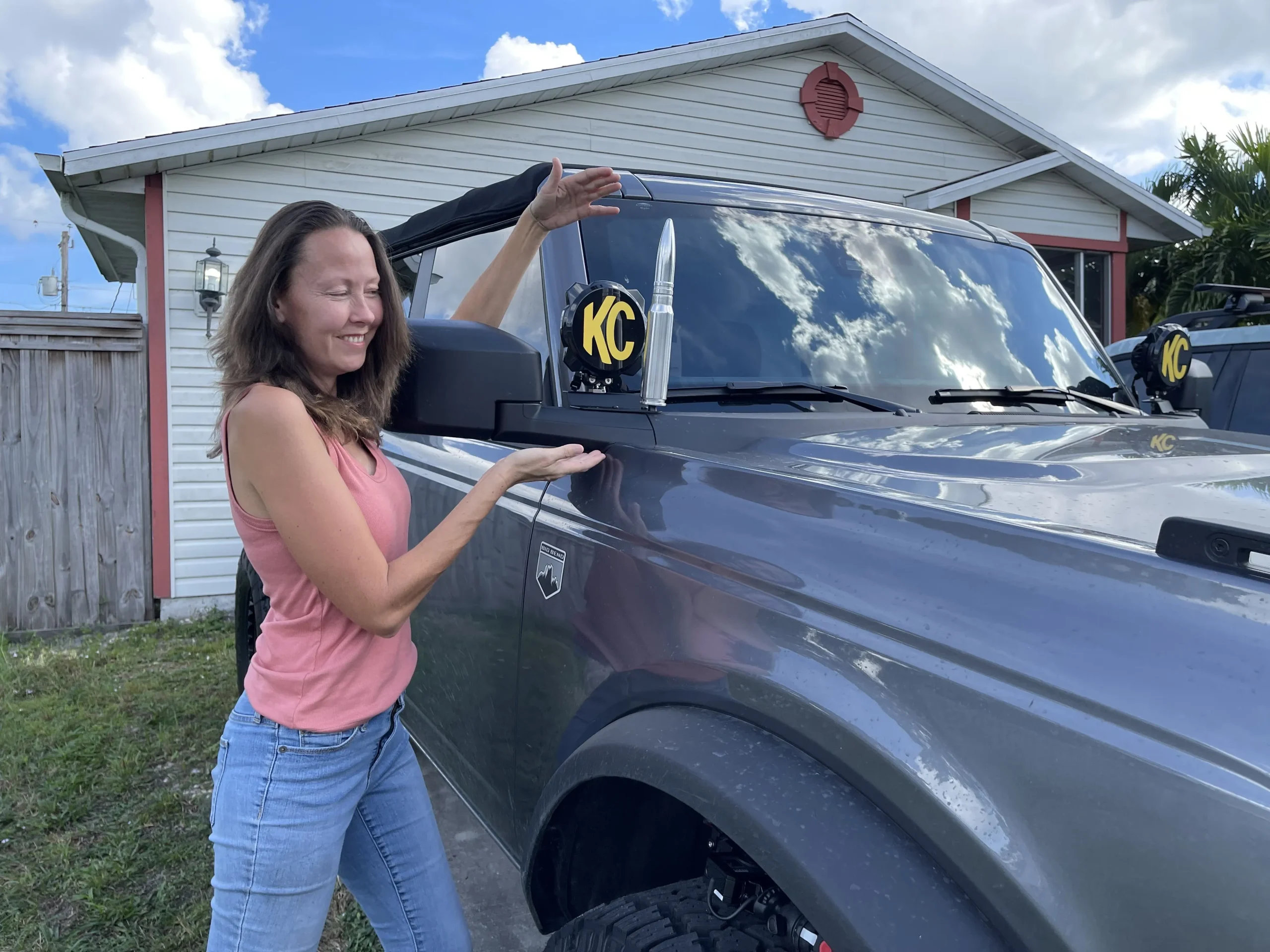 girl showing bullet antenna on truck